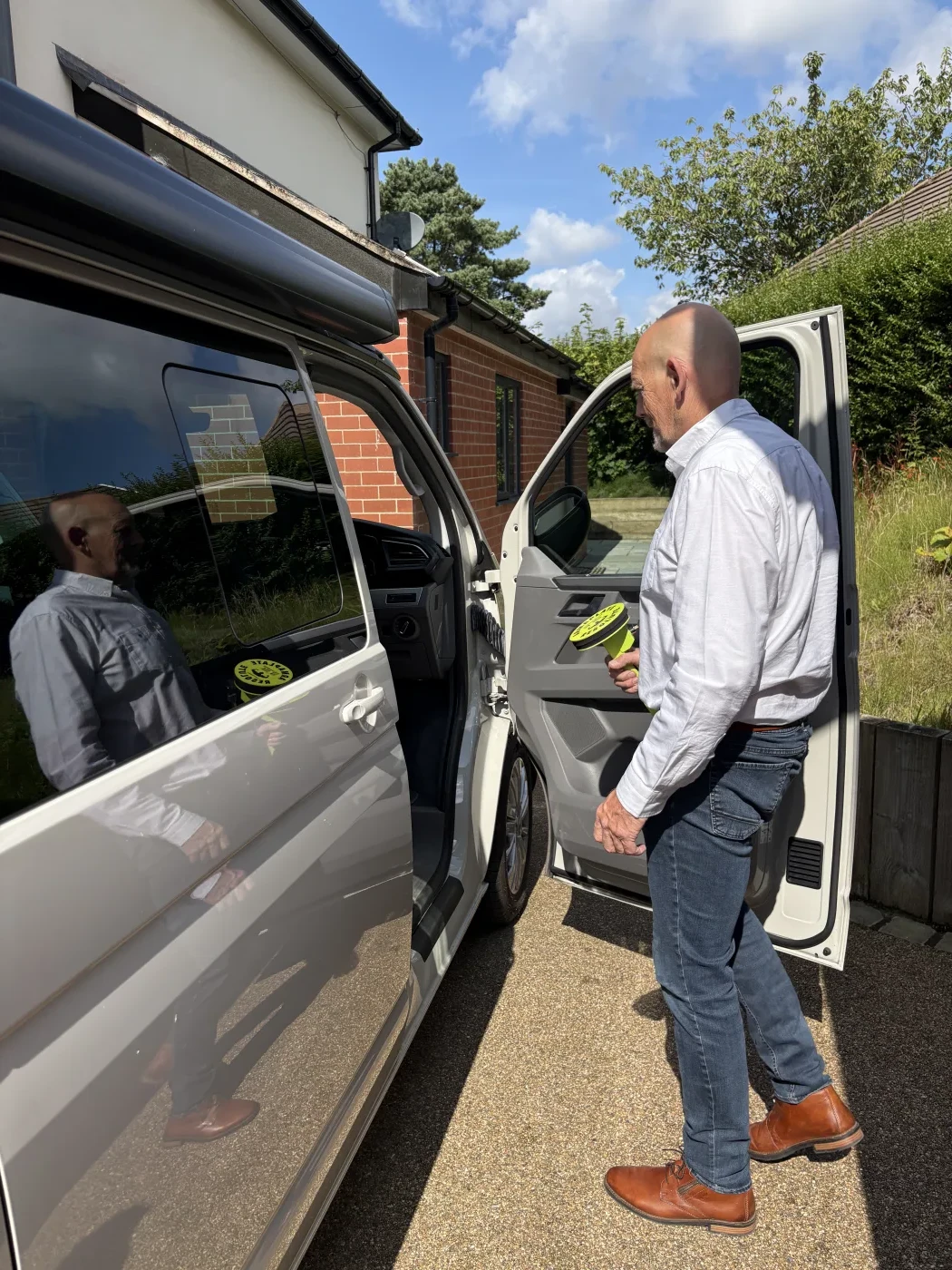 Resolute Compact held next to a VW campervan door